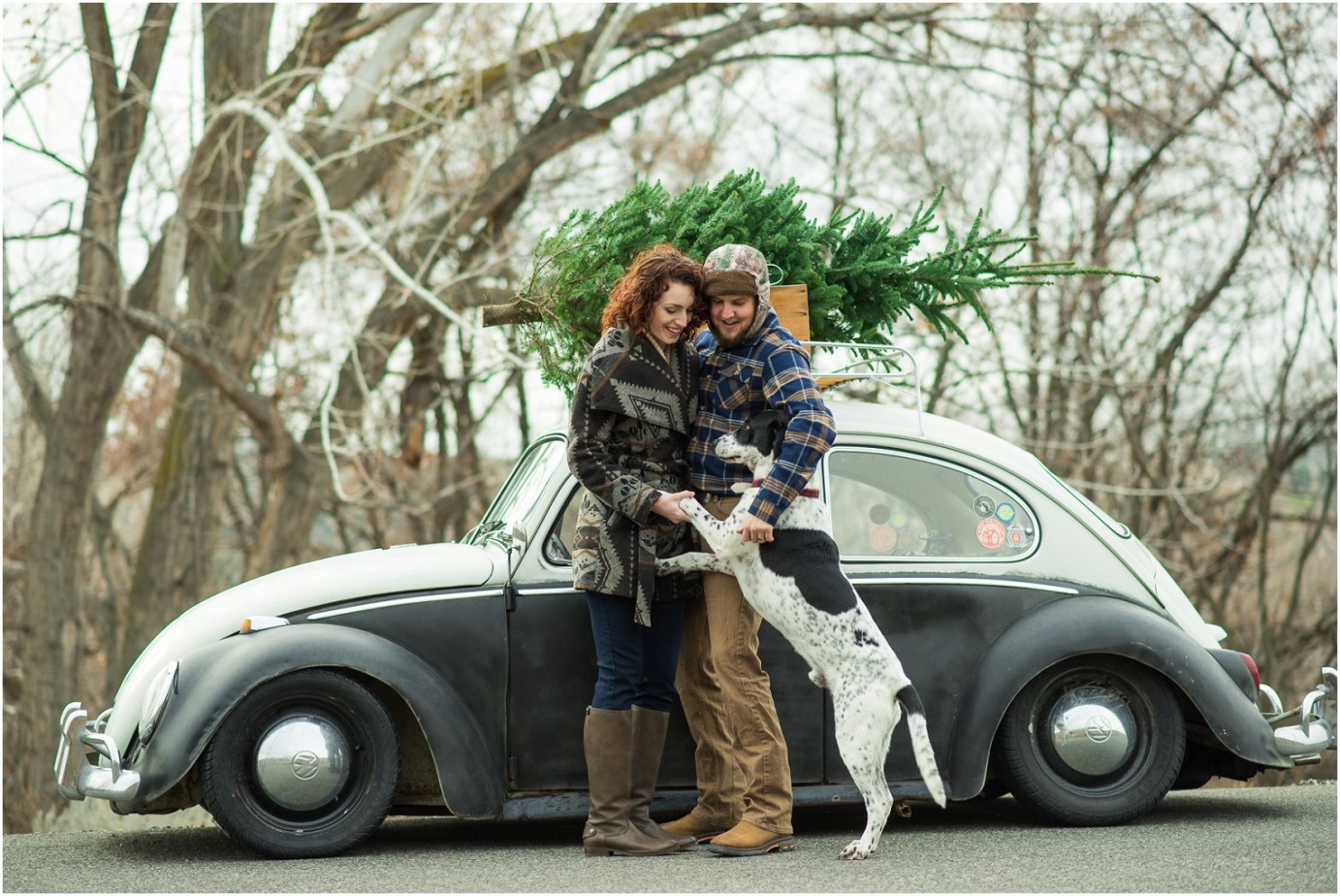 Kennewick Christmas Inspired Couple Shoot couple snuggling with their dog photo
