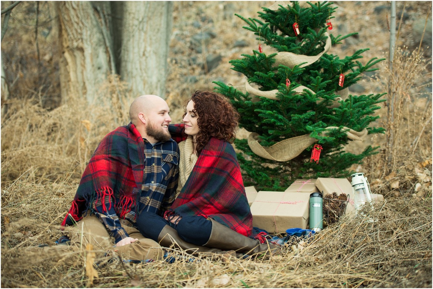 Kennewick Christmas Inspired Couple Shoot couple snuggling in a plaid blanket photo