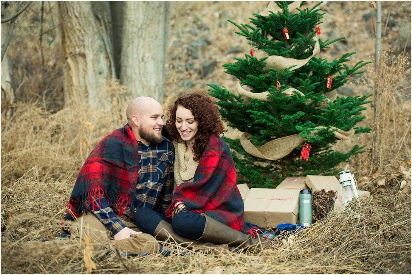 Kennewick Christmas Inspired Couple Shoot couple snuggling in front of Christmas Tree photo