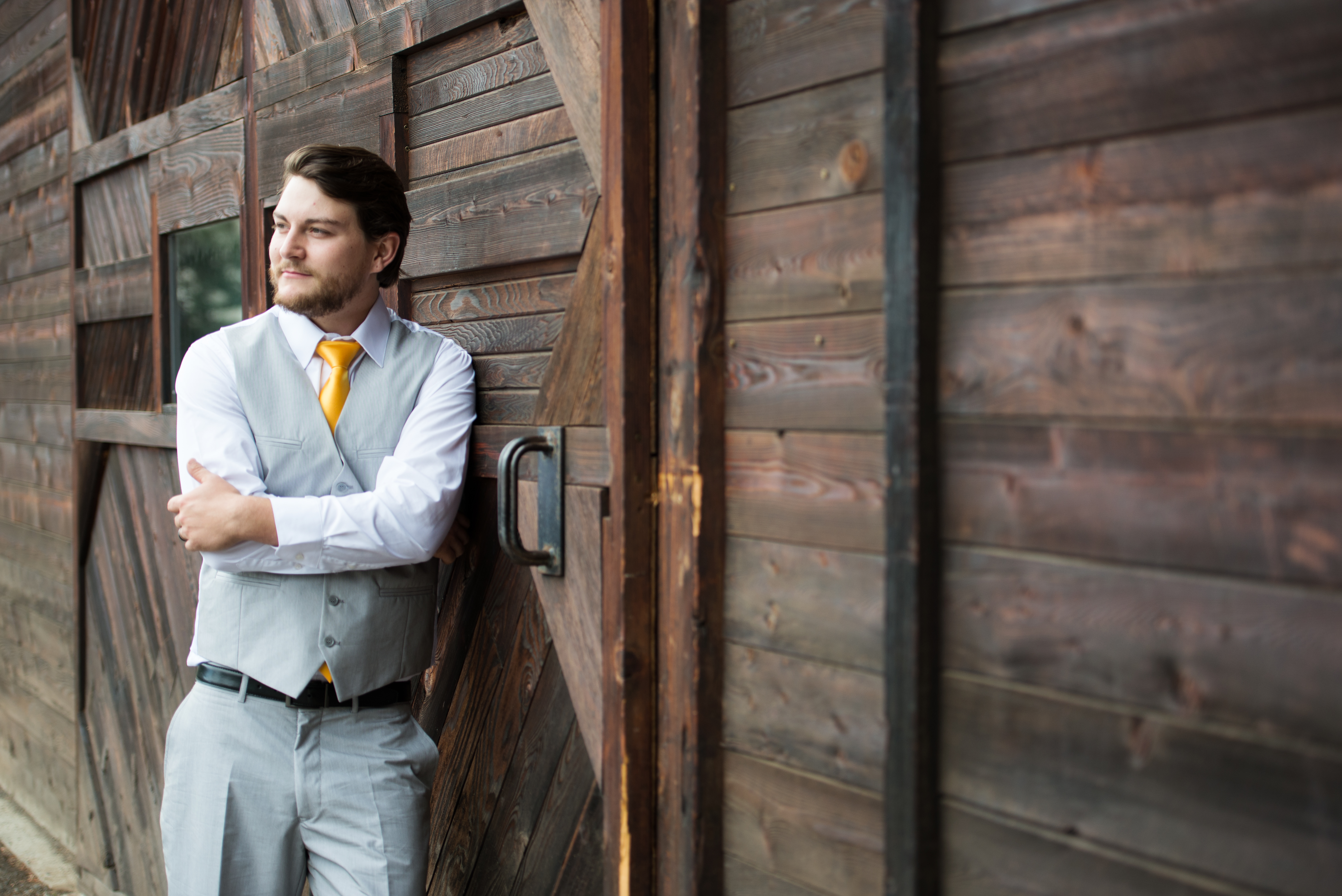 Get your groom involved in wedding planning Groom in grey suit and yellow tie