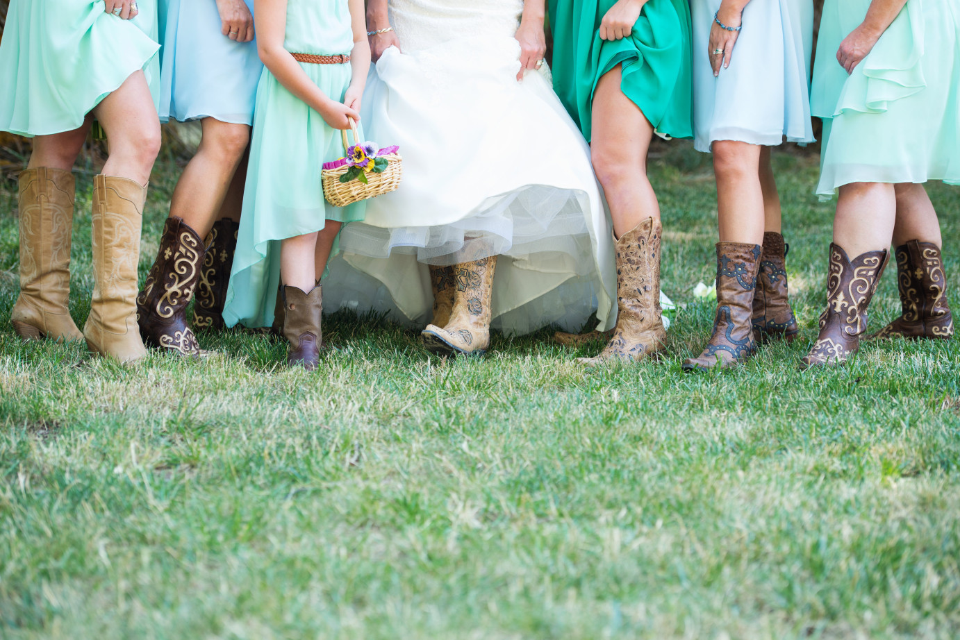 10 Ways to Keep Your Bridesmaids Happy Bridesmaids in gree knee length dresses and cowboy boots