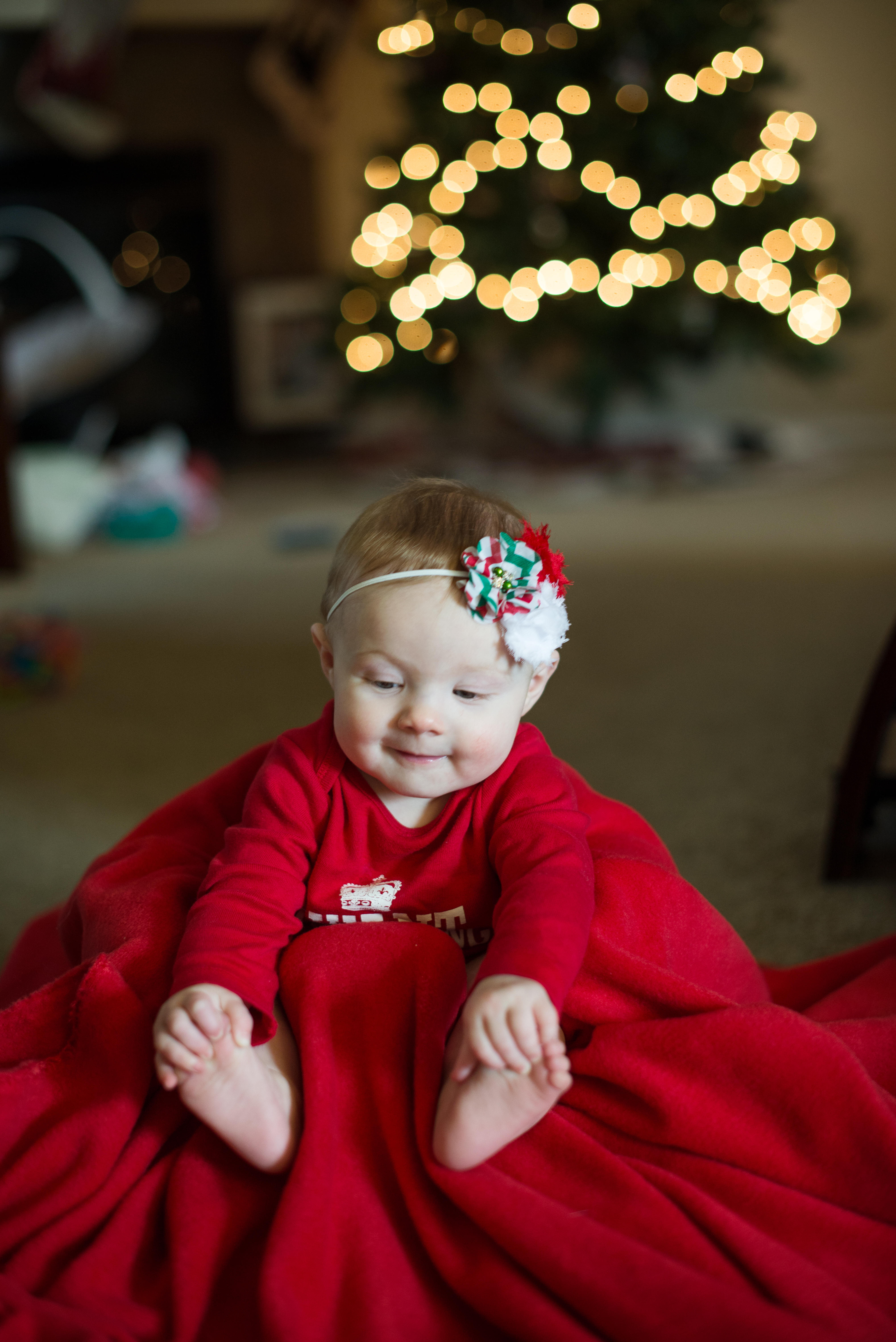 happy birthday raylee 6 month old baby in front of Christmas treevhappy birthday raylee 6 month old baby in front of Christmas tree