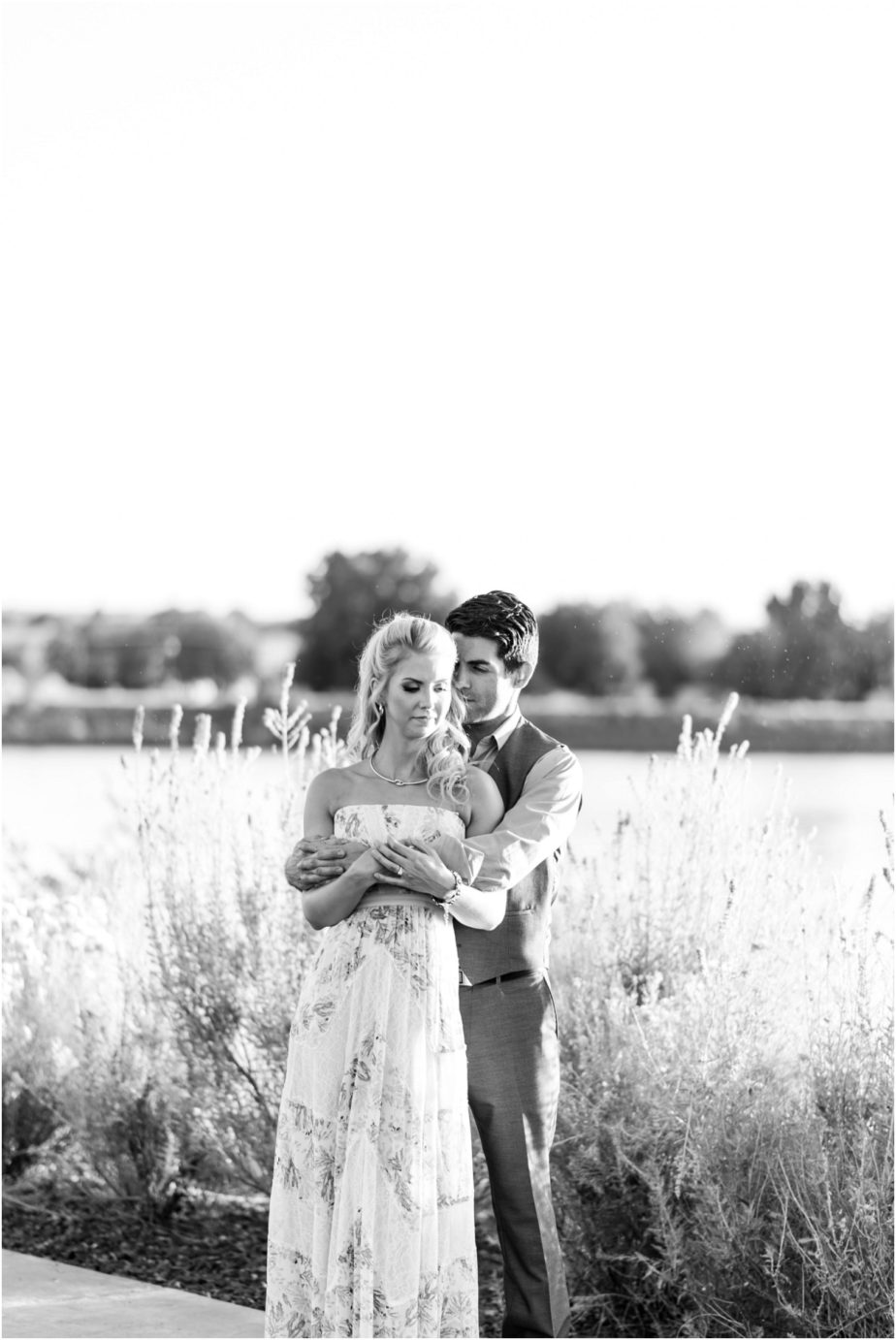 Clover Island Anniversary Session Kennewick WA Couple in the grass by the lighthouse