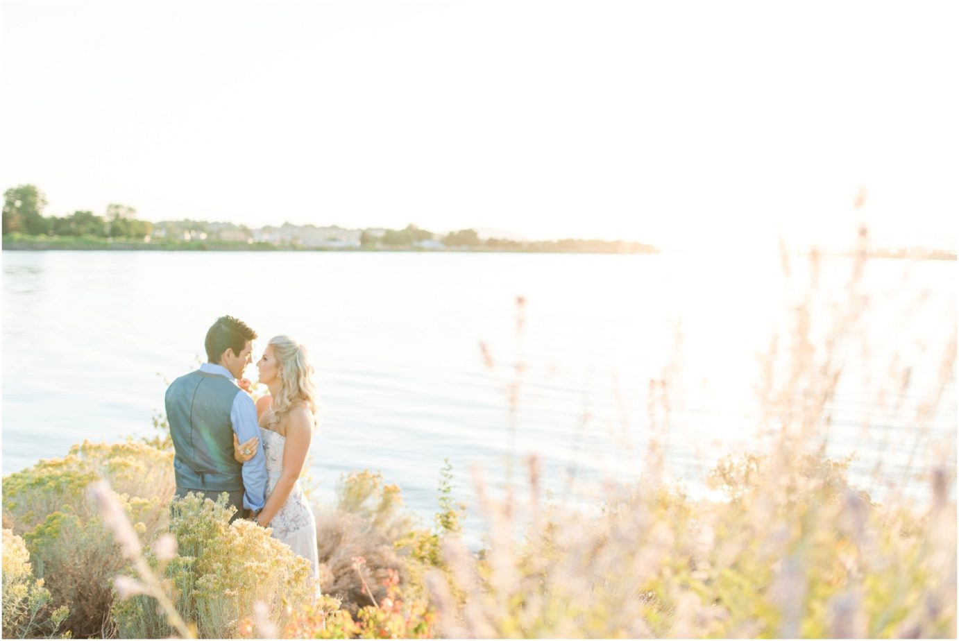 Clover Island Anniversary Session Kennewick WA Couple in the grass by the lighthouse