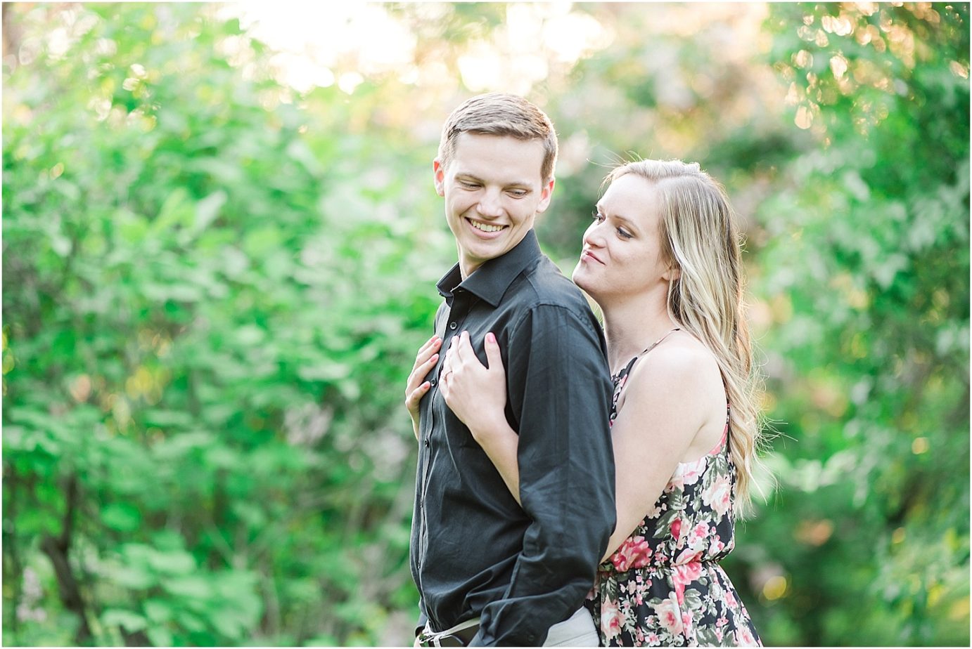 Manito Park Engagement Session Spokane Photographer Bryan and Olivia snuggling in grove of lilacs