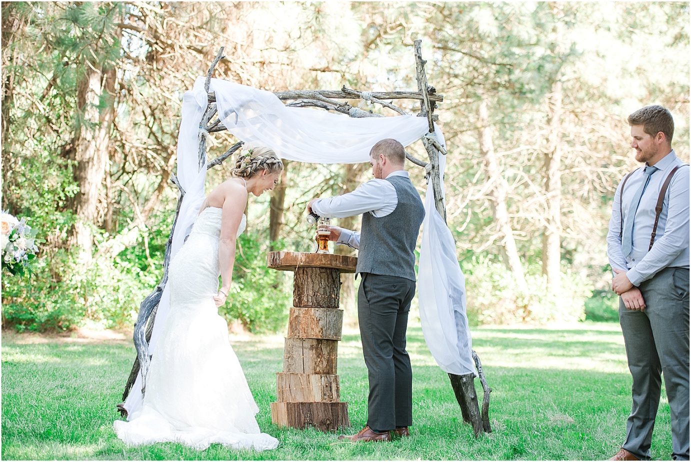 Elk Haven Equestrian Center Wedding Cle Elum Photographer Adam and Jessica bride and groom pouring a black and tan