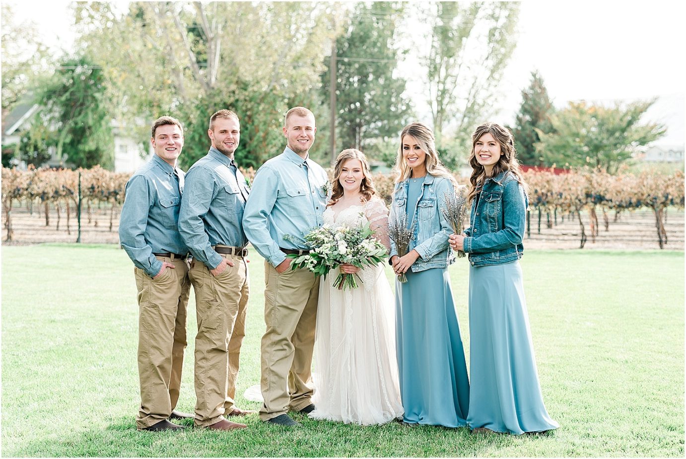 Sugar pine barn wedding tucannon cellars Brandon and Chloe bridal party in dusty blue dresses and khakis
