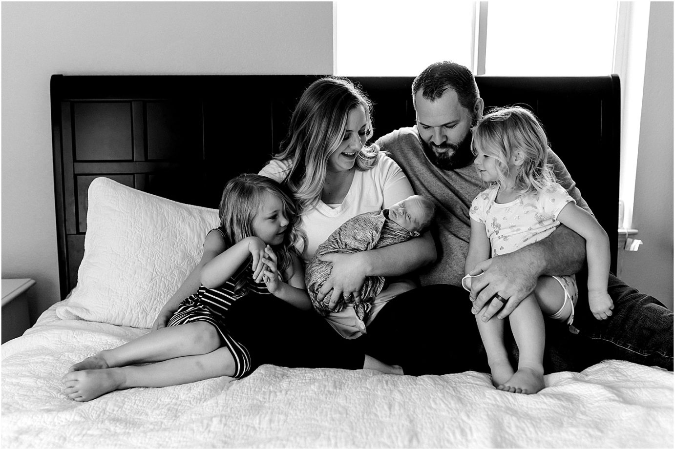 lifestyle newborn session family on bed together