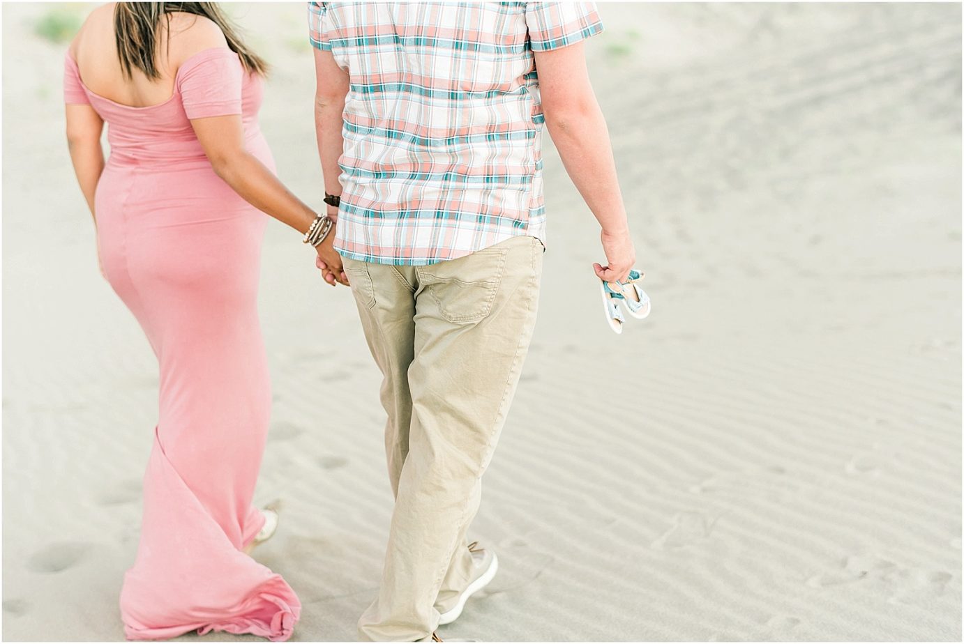 desert maternity session mom to be in blush pink dress on a sand dune