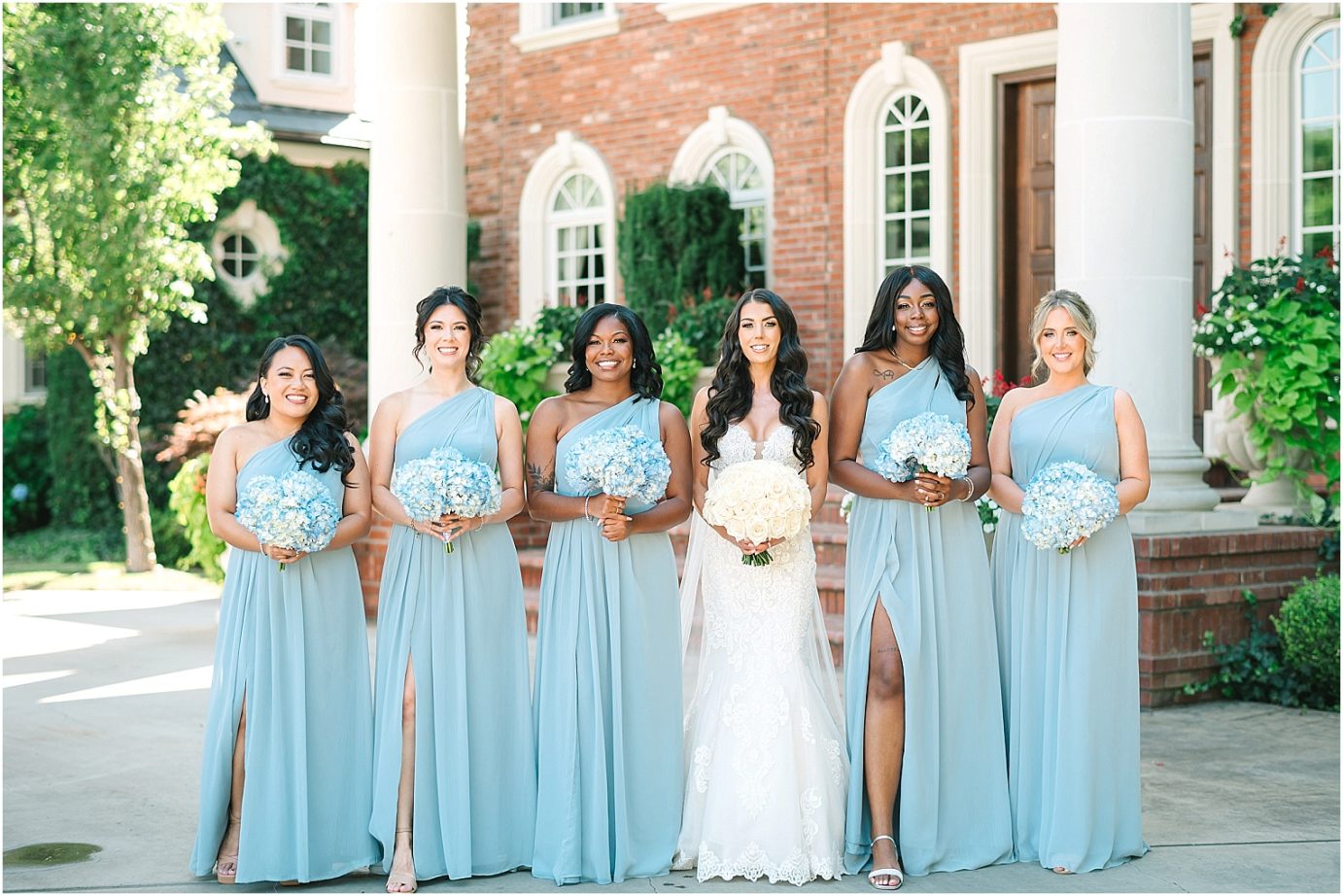 Disney-inspired Oakshire Estate Wedding bride and bridesmaids in dusty blue dresses