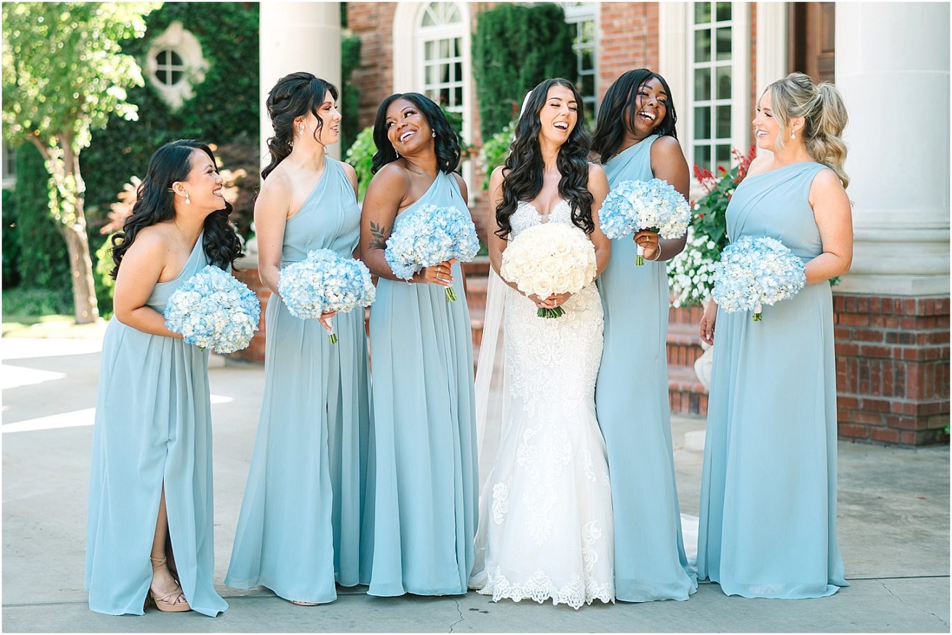 Disney-inspired Oakshire Estate Wedding bride and bridesmaids in dusty blue dresses
