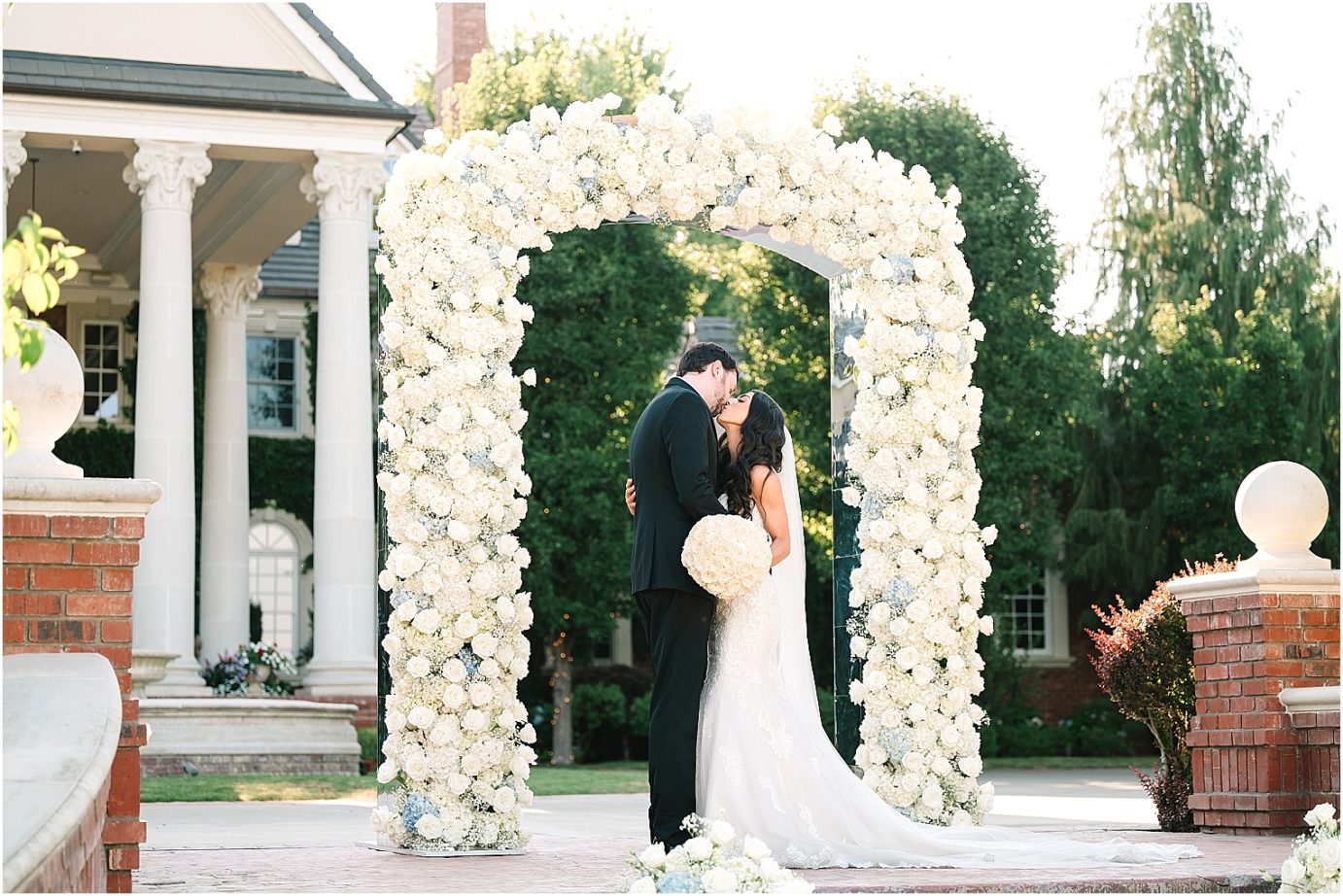 Disney-inspired Oakshire Estate Wedding bride and groom in front of ceremony decor
