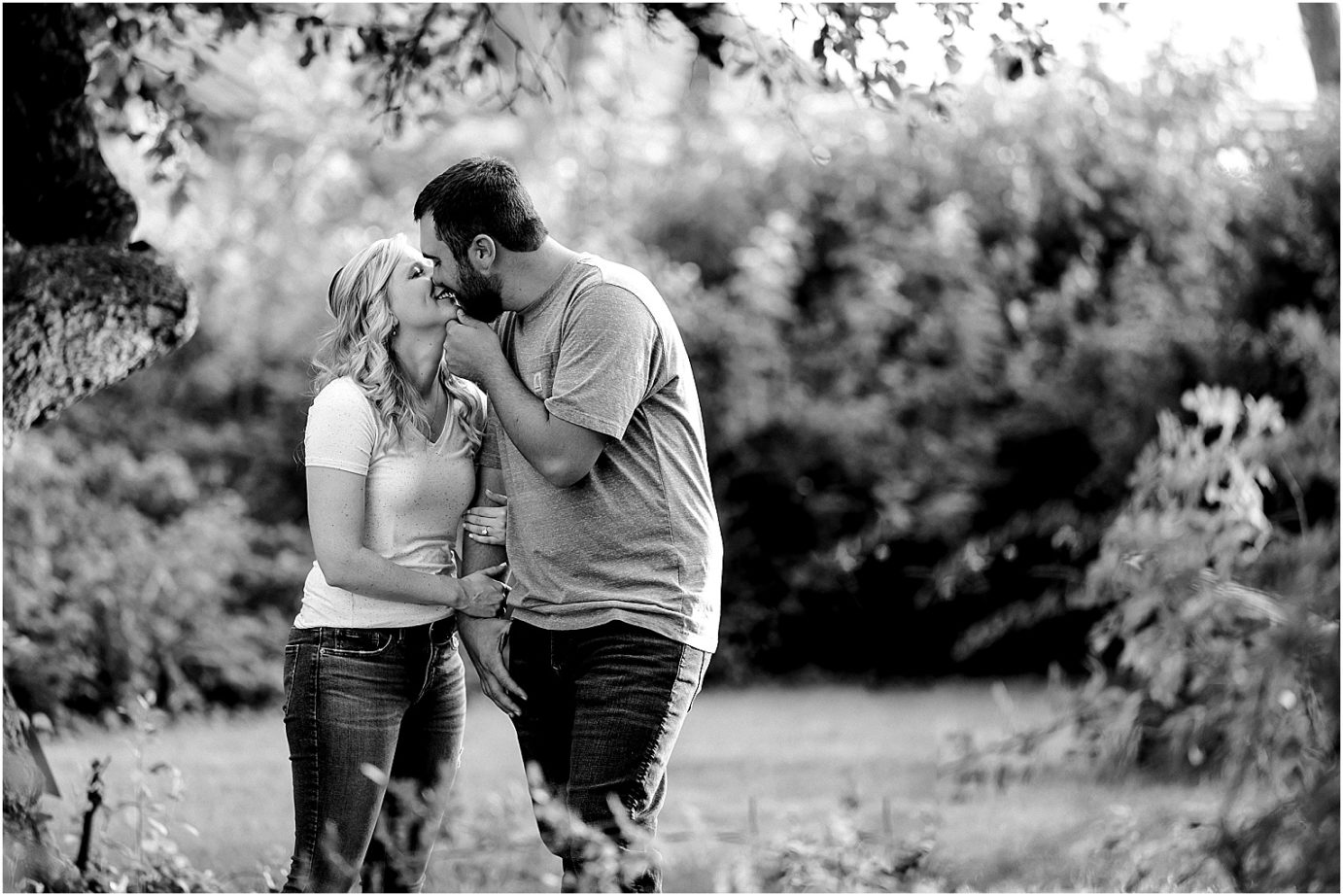 couple kissing during their garden engagement session