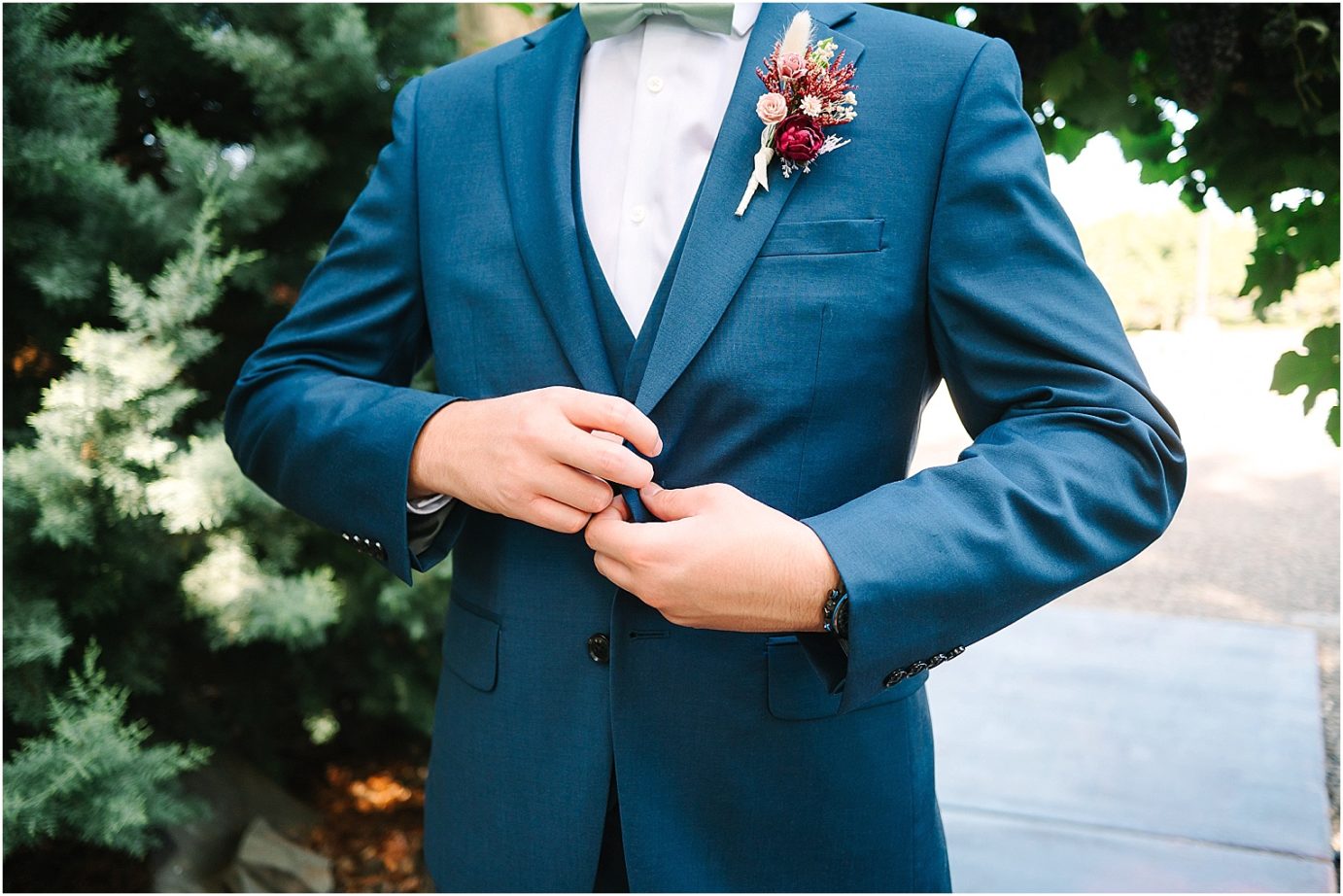 Wedding at Sugar Pine Barn - groom wearing navy tux with fall colored boutonniere 