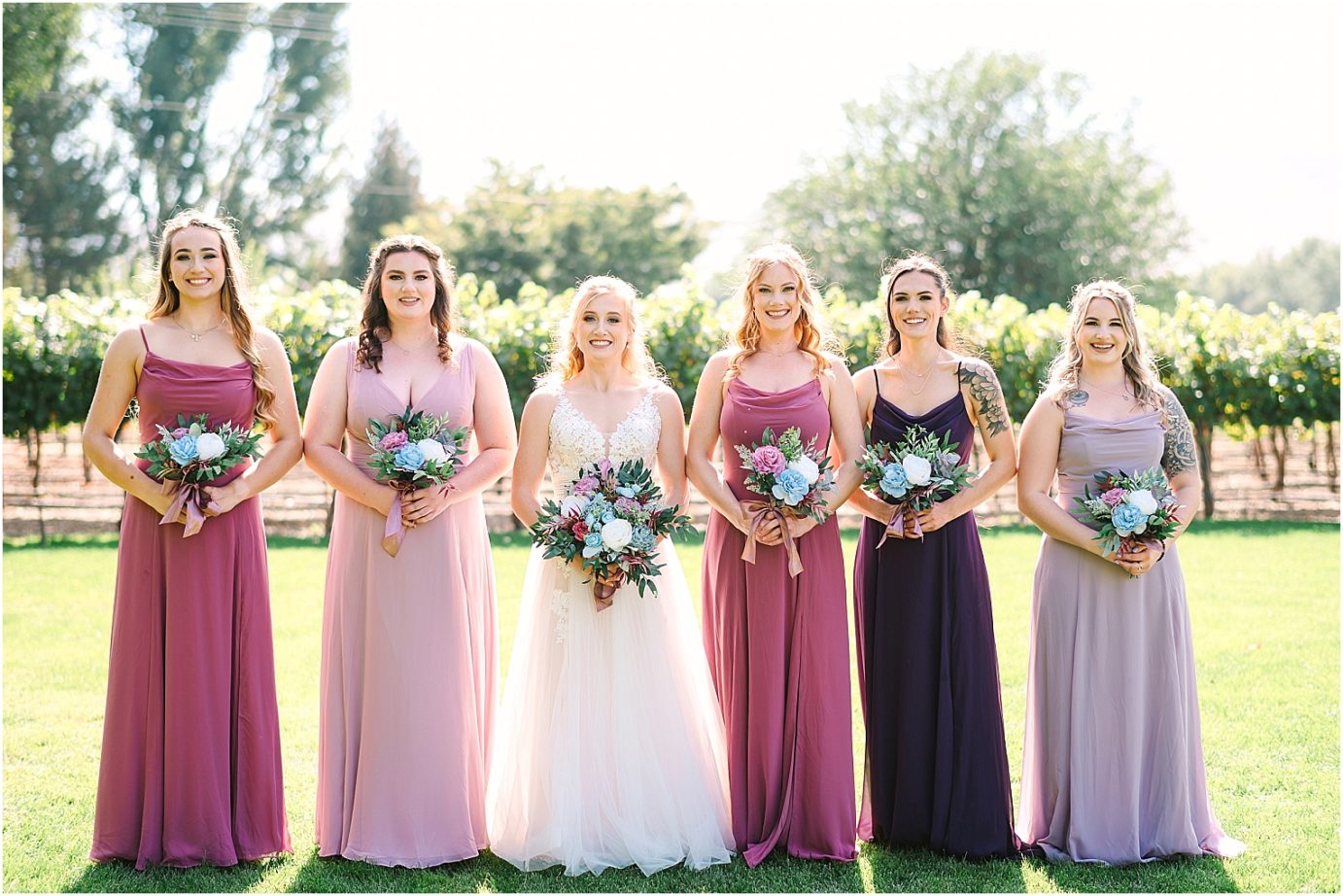 Wedding at Sugar Pine Barn - bride and bridesmaids wearing different colors of purple