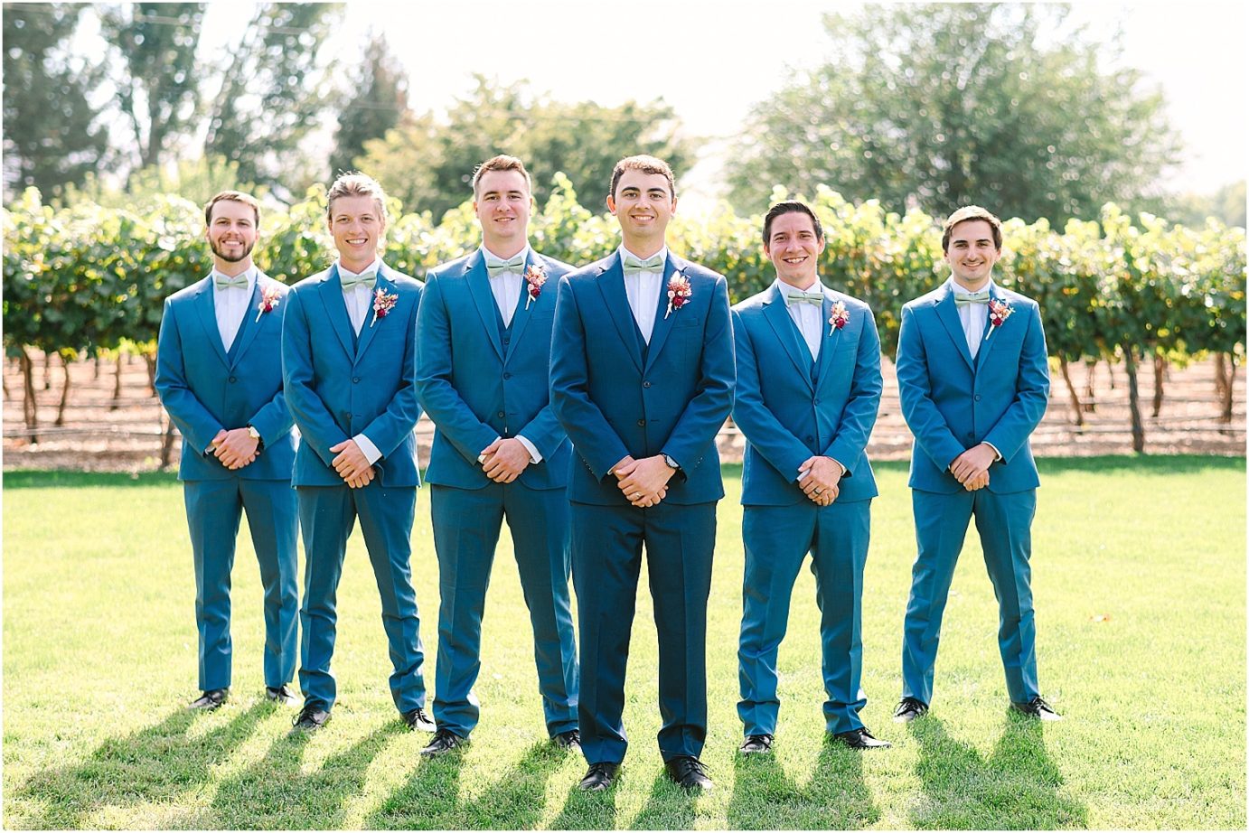 Wedding at Sugar Pine Barn - groom and groomsmen wearing navy tux with fall colored boutonniere