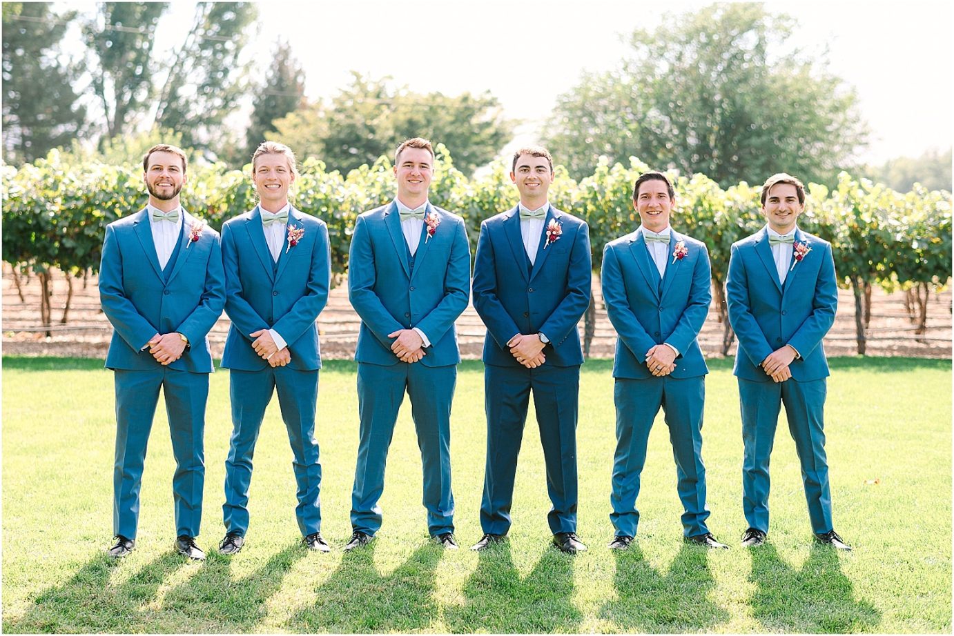 Wedding at Sugar Pine Barn - groom and groomsmen wearing navy tux with fall colored boutonniere