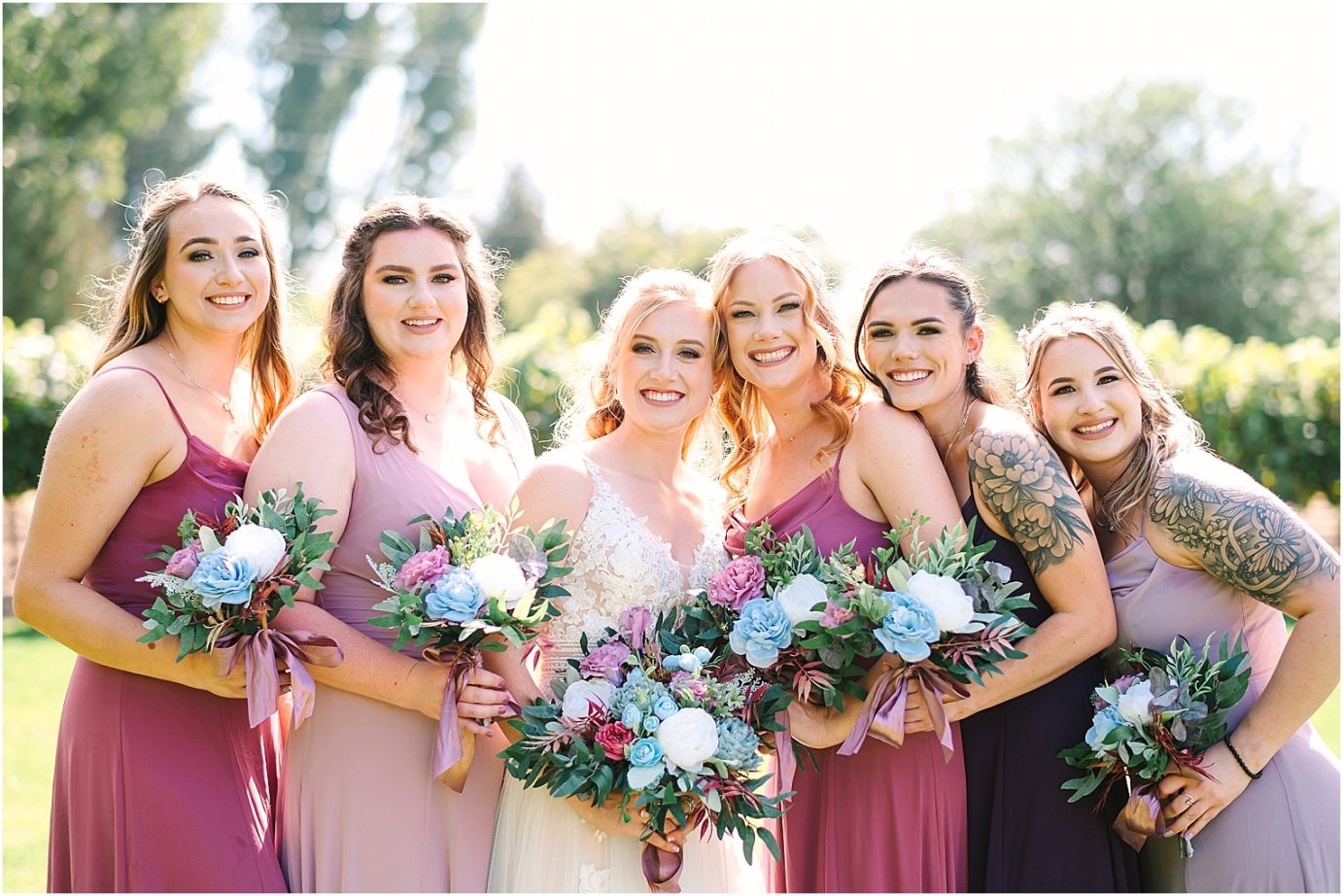 Wedding at Sugar Pine Barn - bride and bridesmaids wearing different colors of purple