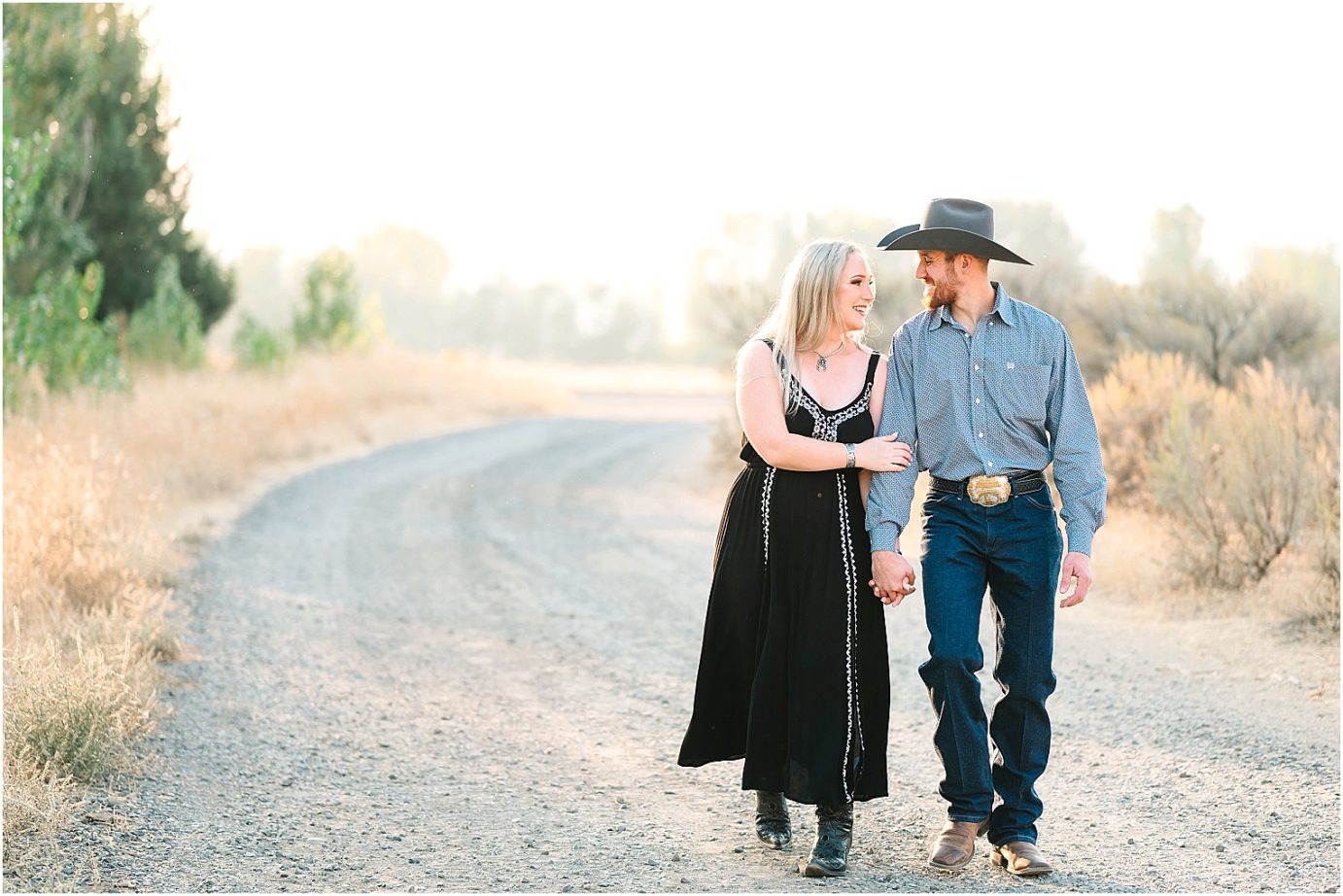 Engagement session in the desert Central WA Andrew and Shelby couple walking wearing western attire