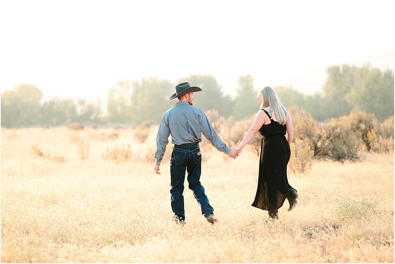 Engagement session in the desert Central WA Andrew and Shelby couple walking in a golden field