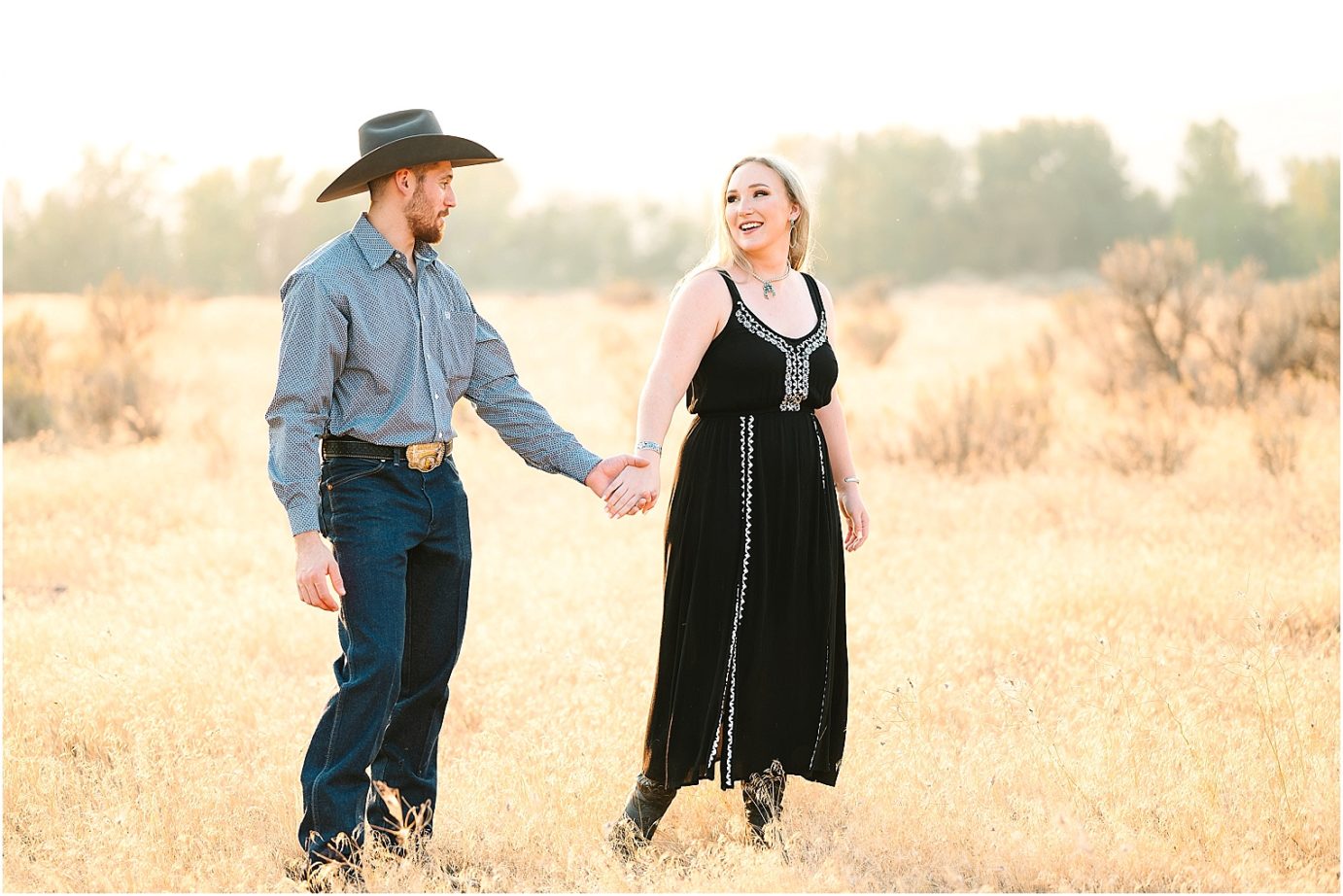 Engagement session in the desert Central WA Andrew and Shelby couple leading each other through a golden field