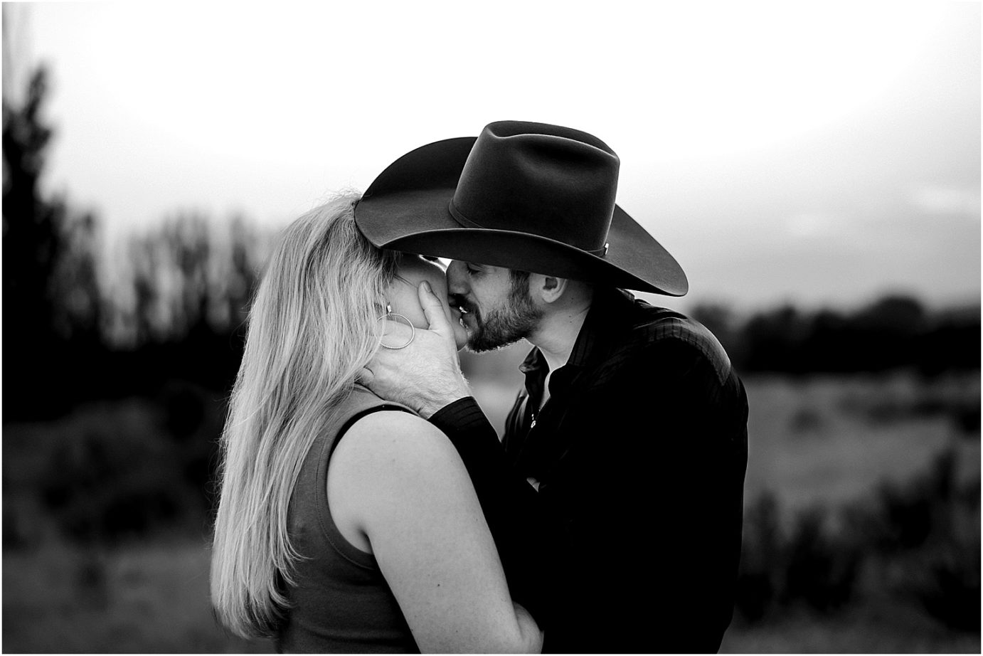 Engagement session in the desert Central WA Andrew and Shelby snuggling under a cowboy hat