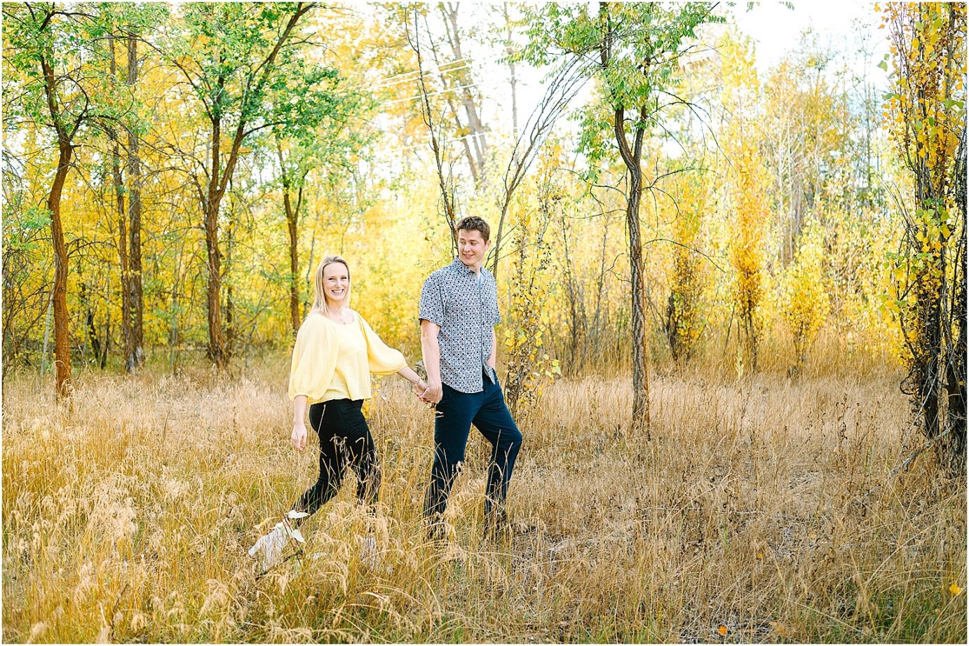 Joyful fall engagement session Cental WA Brad and Jasmine couple walking in tall grass