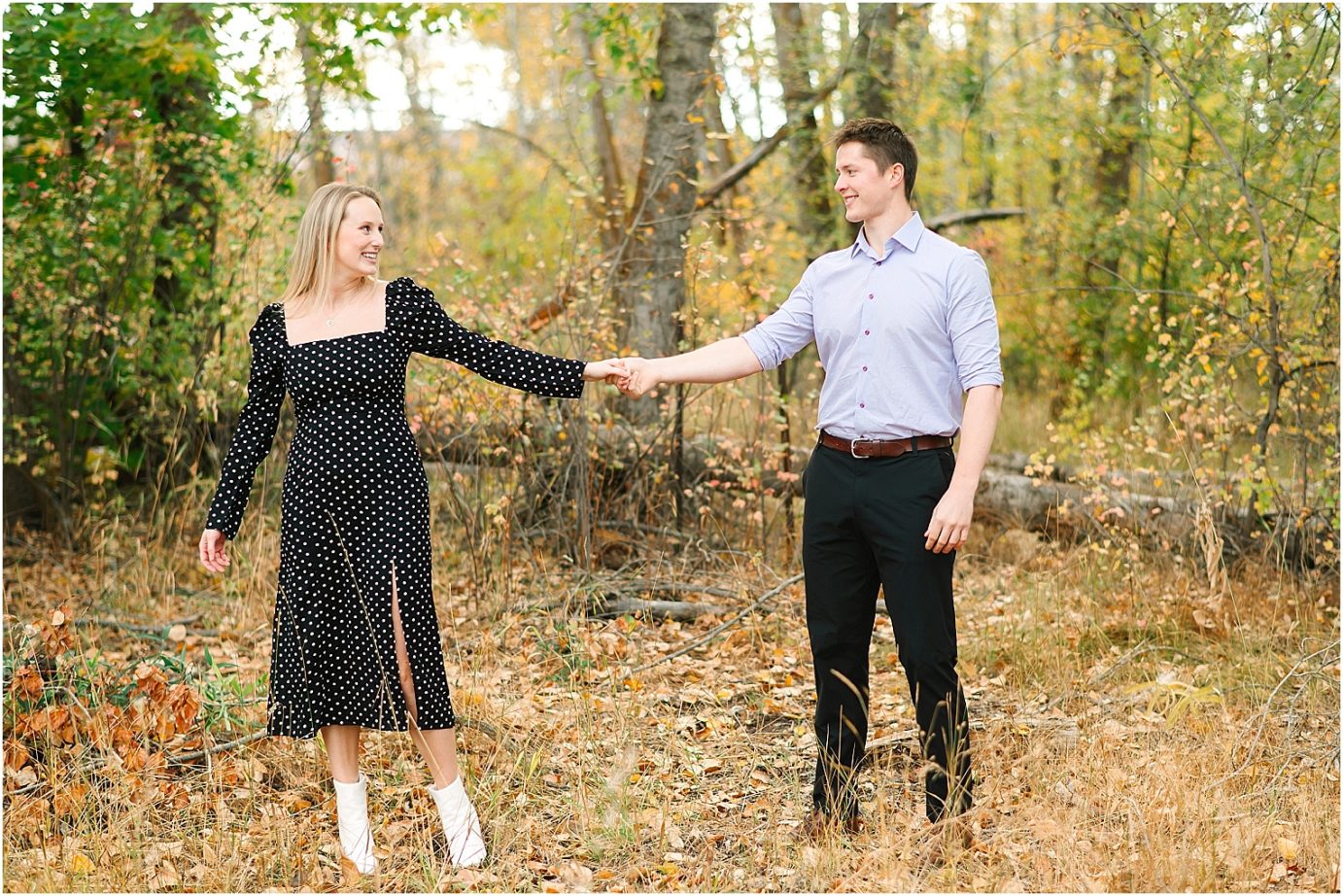 Joyful fall engagement session Cental WA Brad and Jasmine dancing in front of trees