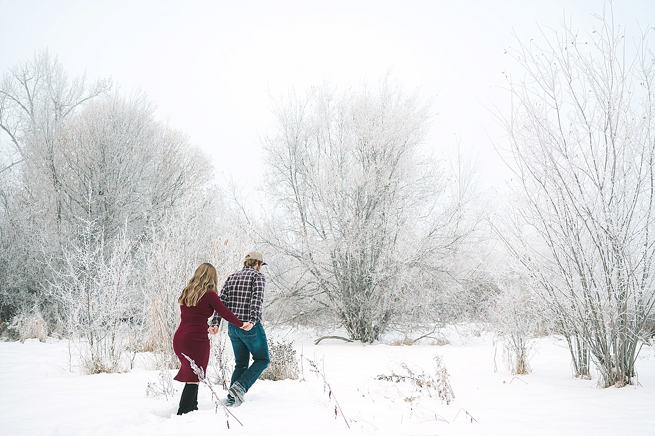 Snowy Ellensburg engagement session couple standing in a meadow of snow