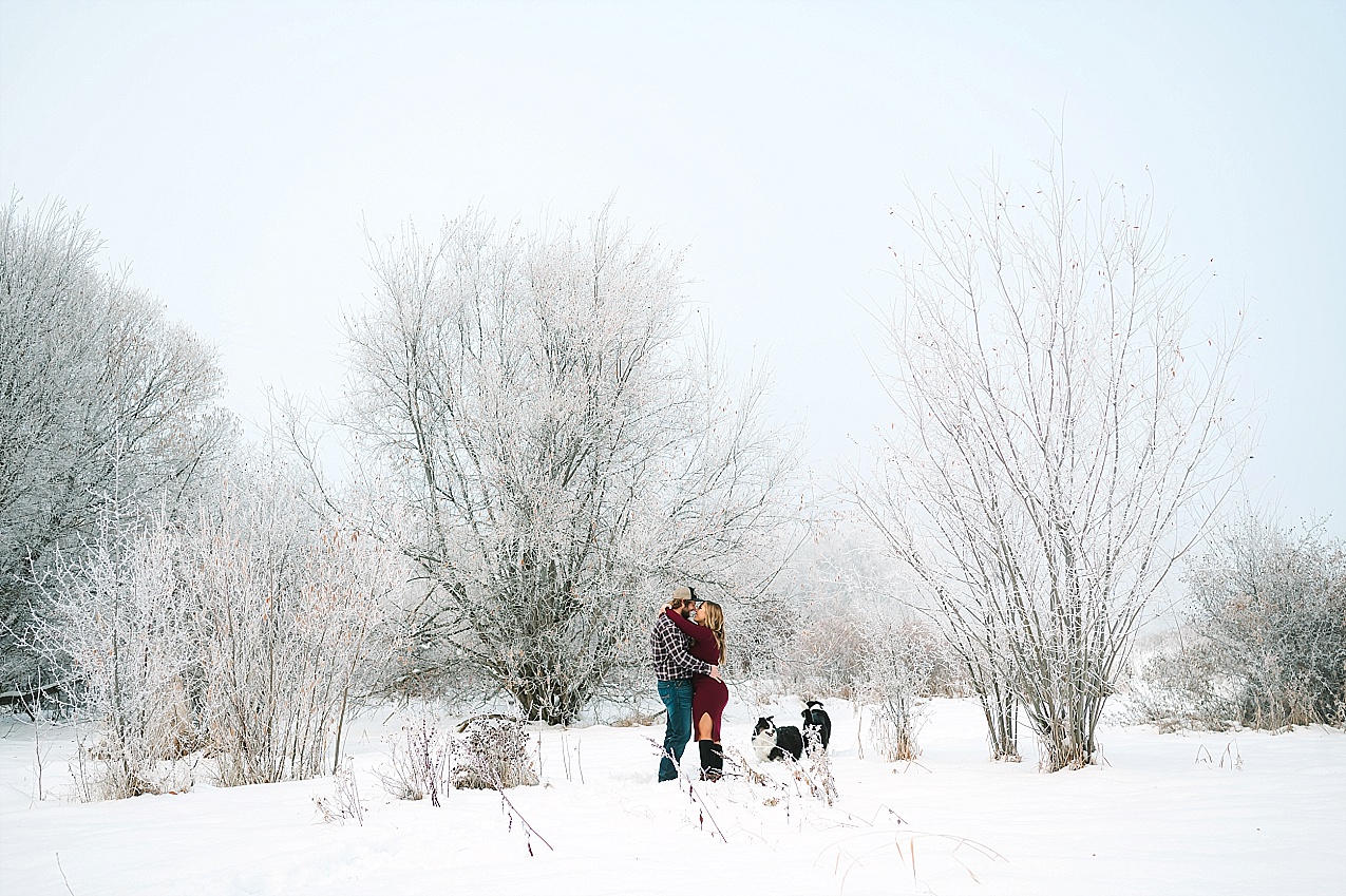 Snowy Ellensburg engagement session couple standing in a meadow of snow