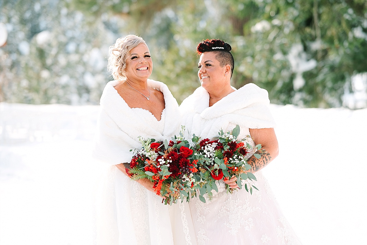 Wintery Pine River Ranch wedding bride and bride in dresses in the snow
