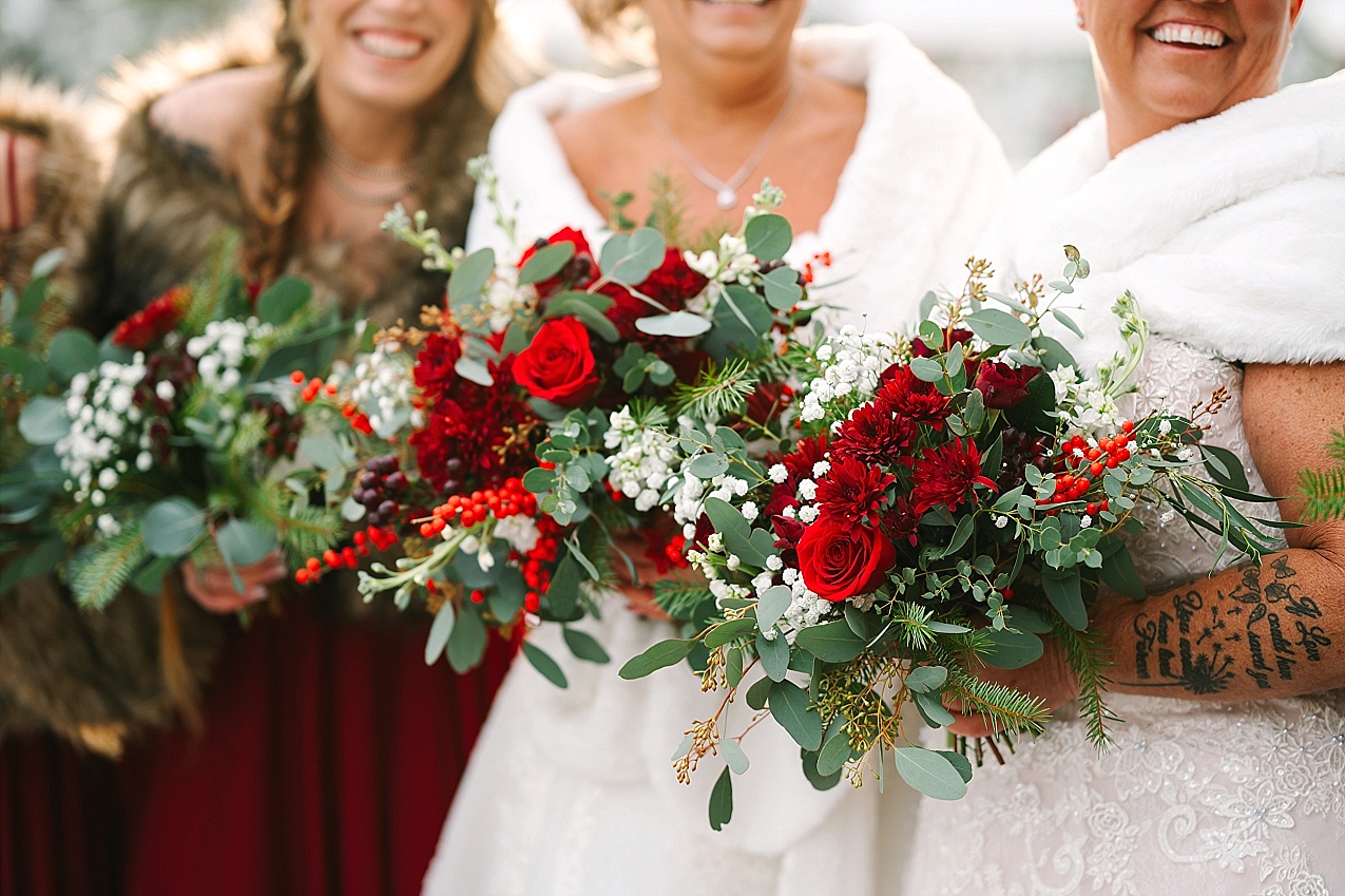 Wintery Pine River Ranch Wedding wedding party with maroon and green flowers