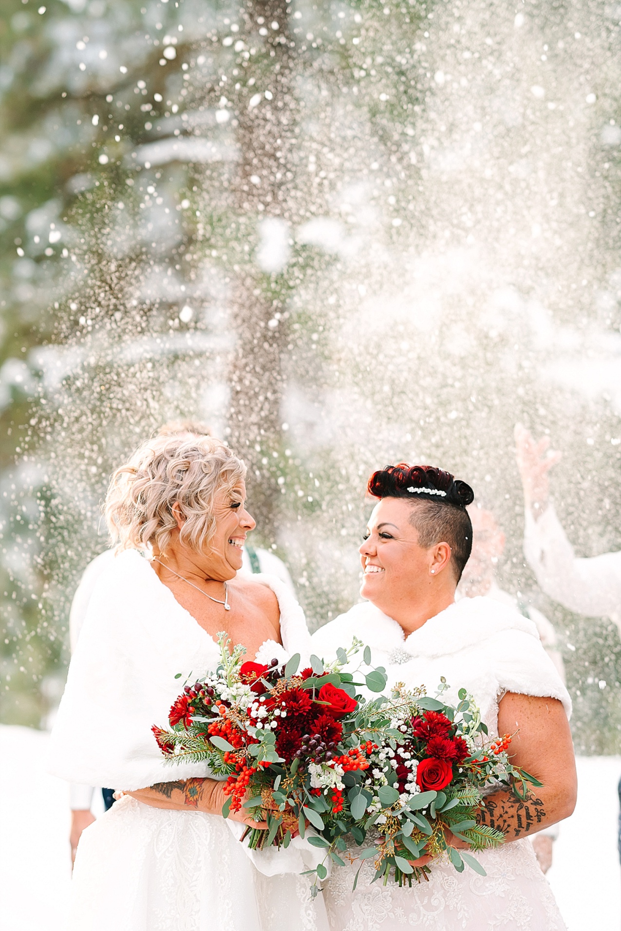 Wintery Pine River Ranch Wedding brides standing while bridesmen throw slow in the air