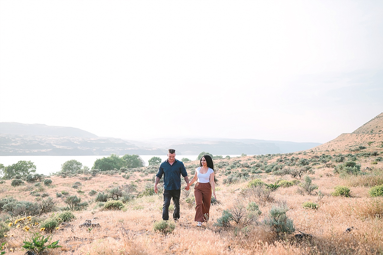 Eastern Washington engagement session Nathan and Ashley walking in a field