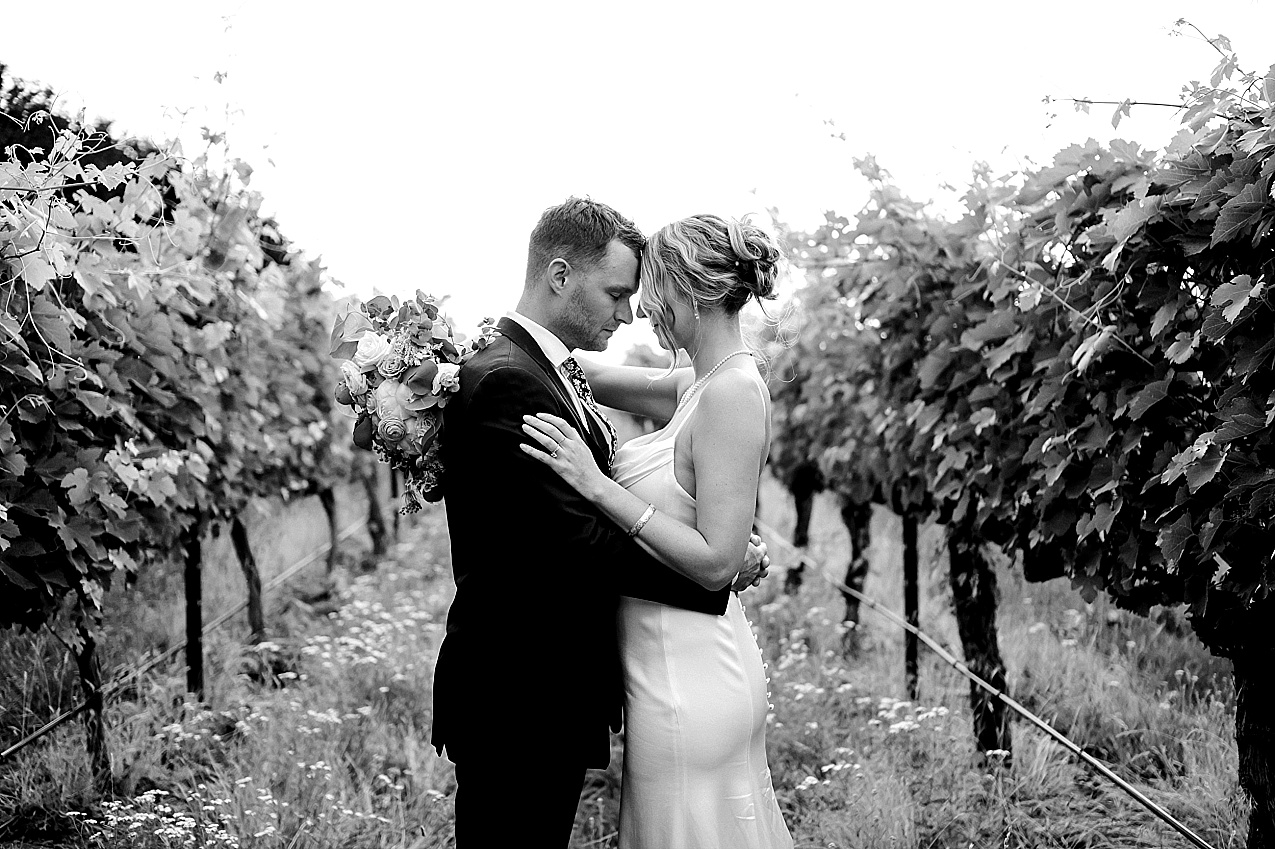Wedding Walla Walla James and Melissa bride and groom in winery rows