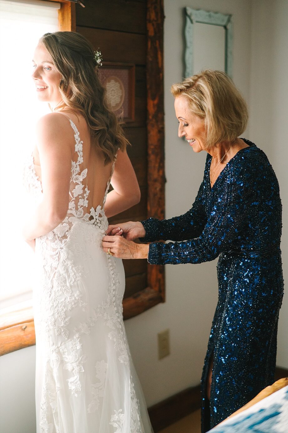 Photographer Bailey and Nikkie bride's mom helping bride in dress