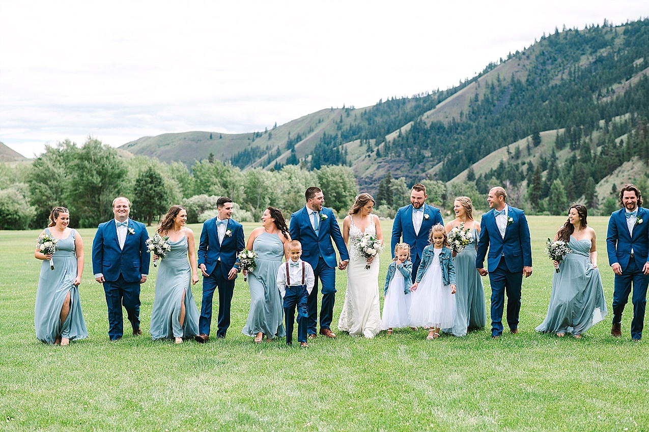 American Homestead Wedding Naches Photographer Bailey and Nikkie full wedding party walking together in a field