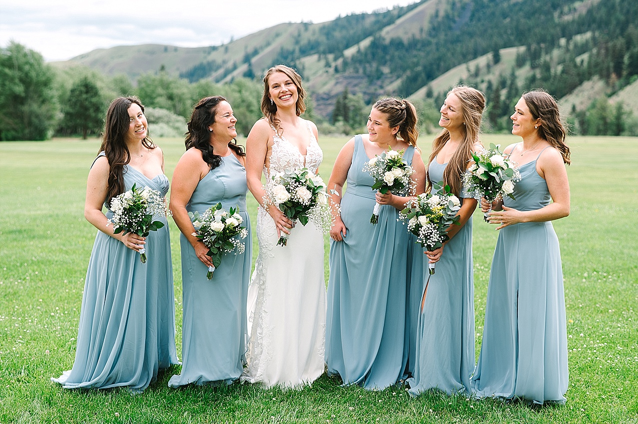 American Homestead Wedding Naches Photographer Bailey and Nikkie bridal party in blue dresses with white florals