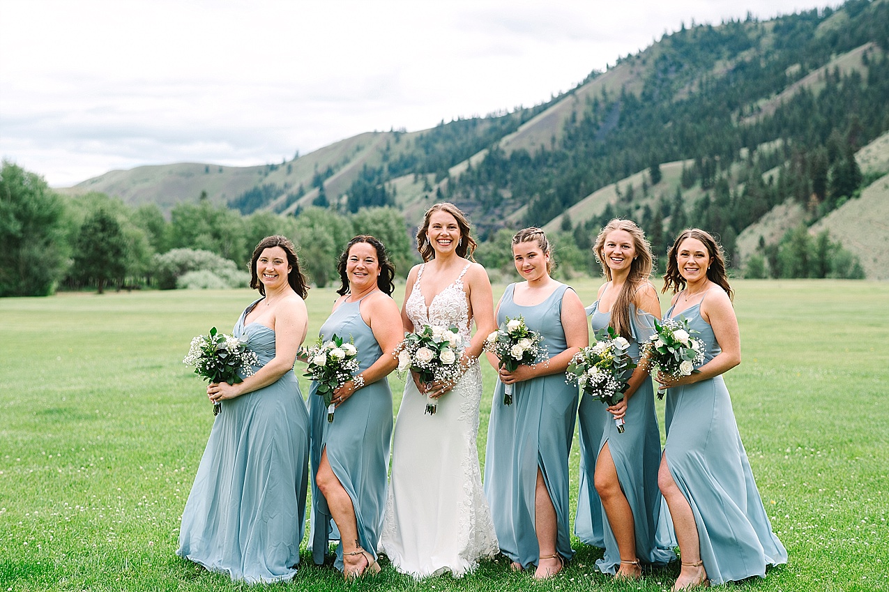 American Homestead Wedding Naches Photographer Bailey and Nikkie bridal party in blue dresses with white florals