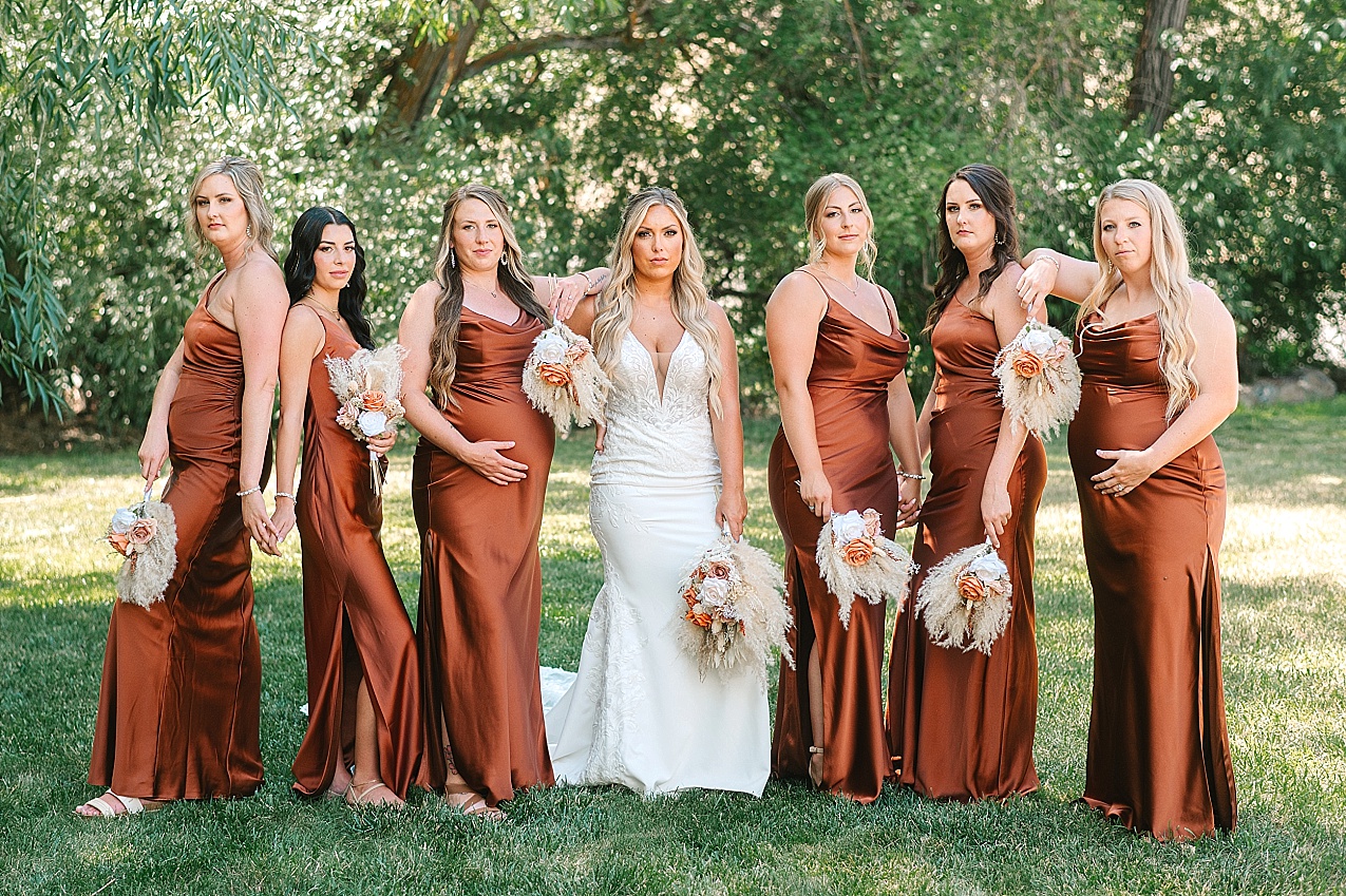 McIntosh Ranch Wedding Ellensburg WA Blake and Korteney bridesmaids in rust colored dresses
