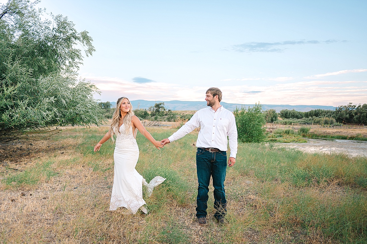 McIntosh Ranch Wedding Ellensburg WA Blake and Korteney bride and groom in a field