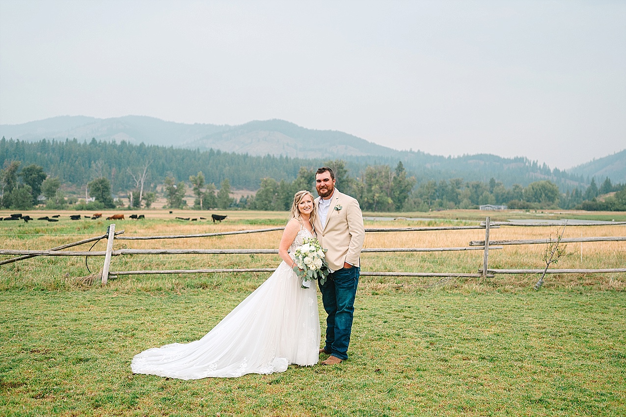 The Cattle Barn Wedding Ellensburg WA Andrew and Dani bride and groom portraits in field