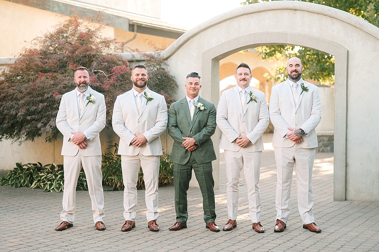 Terra Blanca Winery Wedding Nathan and Ashley groom in green suit and groomsmen in beige