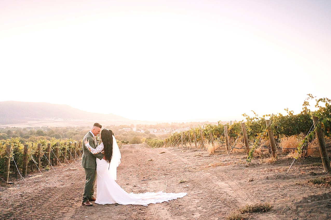 Terra Blanca Winery Wedding Nathan and Ashley kissing in vineyard