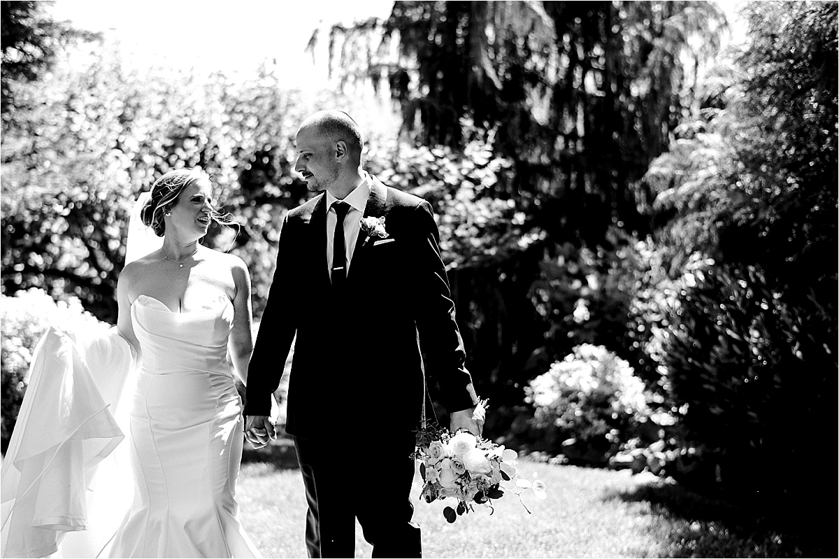 Sugar Pine Barn Wedding Benton City Photographer bride and groom walking through grass field